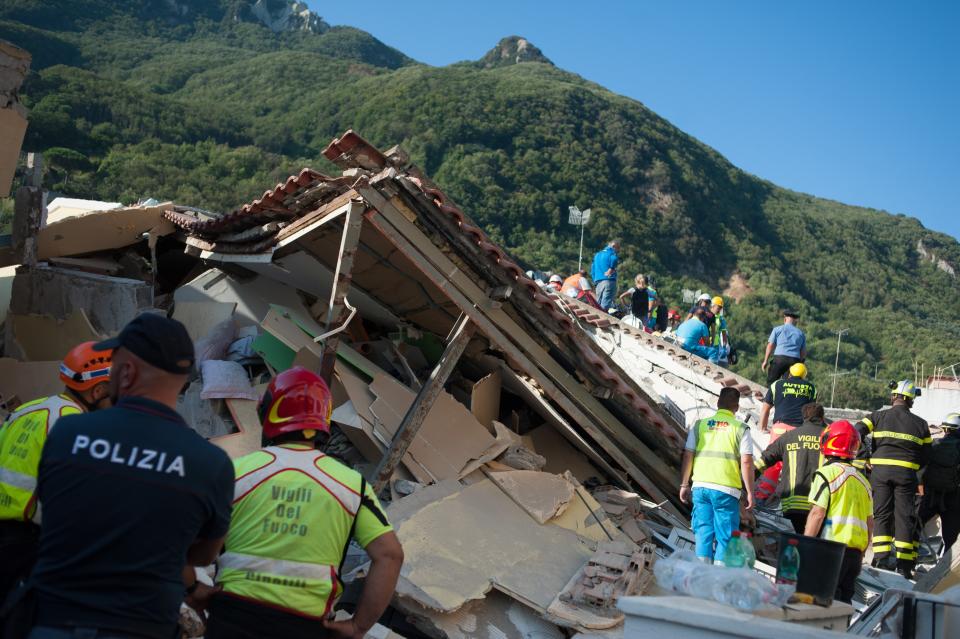 <p>Rescuers dig through the rubble during a search for two missing children on Aug. 22, 2017 in Casamicciola Terme, Italy. (Photo: Ivan Romano/Getty Images) </p>