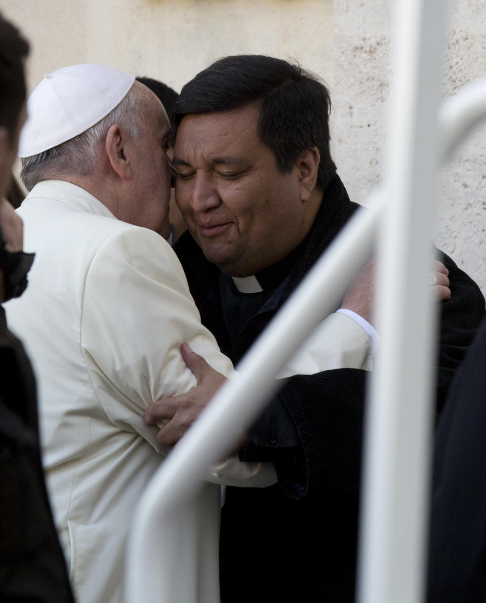 Pope Francis greets Rev. Fabian Baez, at the end of his weekly general audience in St. Peter's Square at the Vatican, Wednesday, Jan. 8, 2014. Pope Francis has broken with papal protocol once again, inviting his friend Rev. Fabian Baez, a priest from Francis’ hometown in Buenos Aires, for a spin on his popemobile. (AP Photo/Alessandra Tarantino)