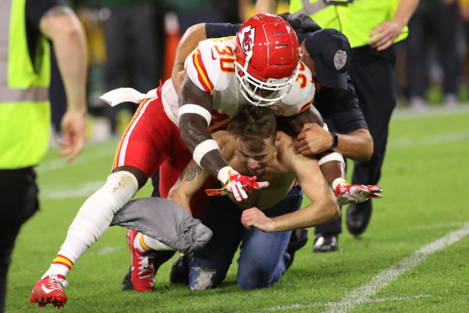 Kansas City Chiefs defensive back Harold Jones-Quartey helps the Green Bay Police Department tackle a fan who ran on the field during a game between the Green Bay Packers and the Kansas City Chiefs at Lambeau Field on Aug. 29. (Photo: Icon Sportswire via Getty Images)