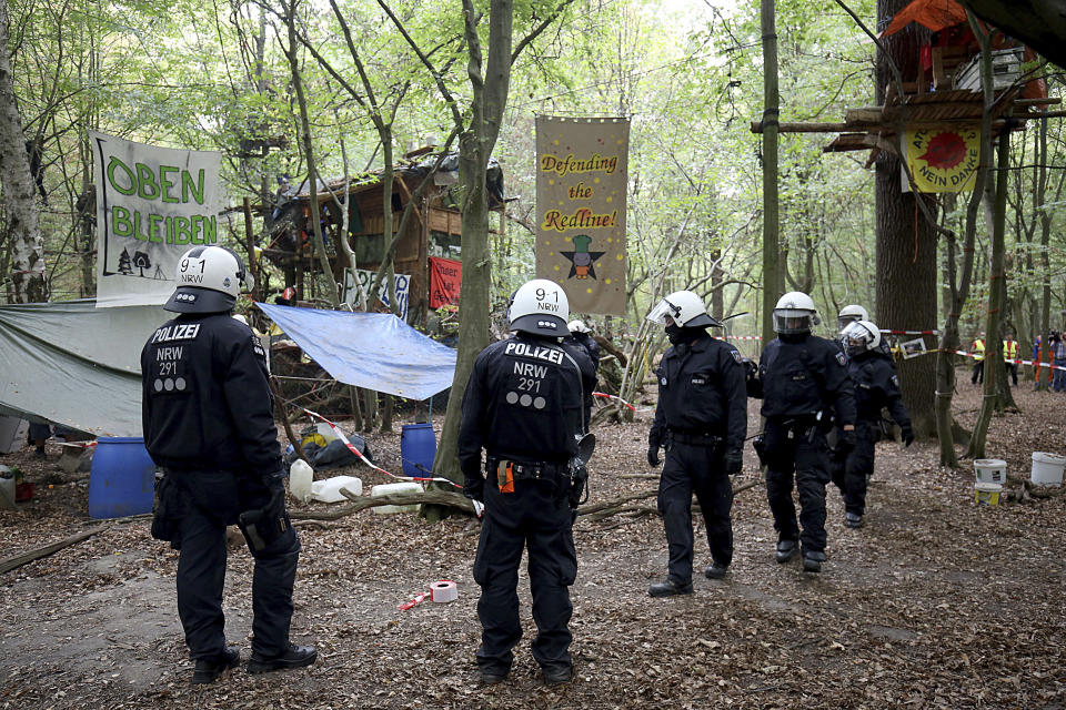 Police enters the 'Hambacher Forest' that protesters are trying to stop from being chopped down for a coal mine in Kerpen, Germany, Wednesday, Sept. 5, 2018. (Oliver Berg/dpa via AP)
