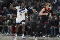 Minnesota Timberwolves center Naz Reid (11) points after making a 3-point shot during the first half of an NBA basketball game against the Toronto Raptors, Wednesday, April 3, 2024, in Minneapolis. (AP Photo/Abbie Parr)