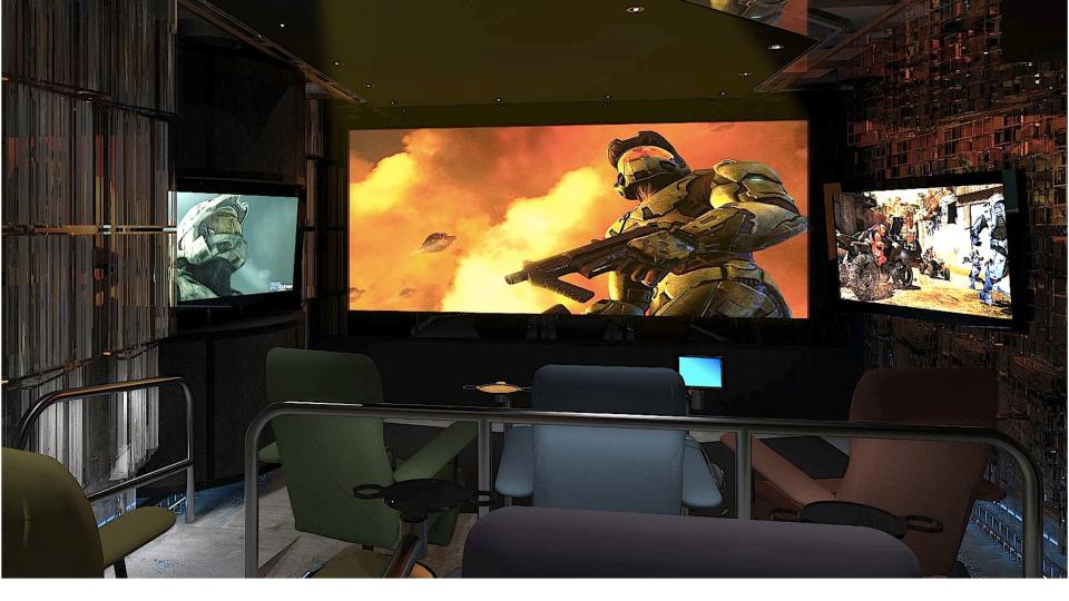 Home theater gaming room showing projection screen and flanking monitors
