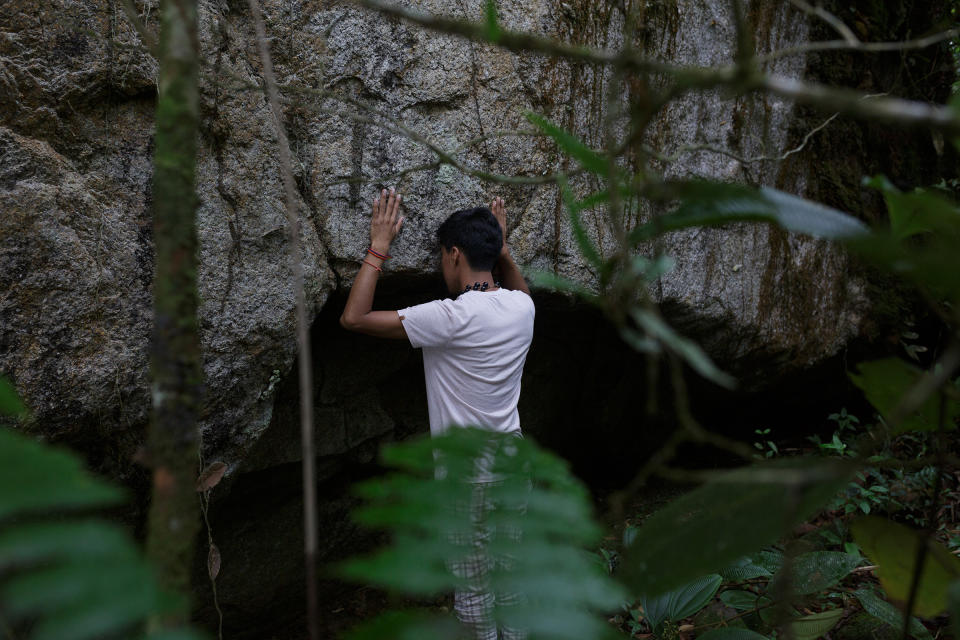 Alexis Grefa, a 26-year-old activist with the Piatúa Resiste Defense Front, near one of the river’s sacred rocks<span class="copyright">Andrés Yépez for TIME</span>