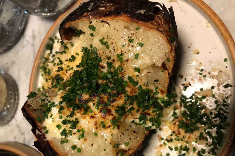 Ember baked potato with gouda cheese and creme fraiche at Pasture in Cardiff