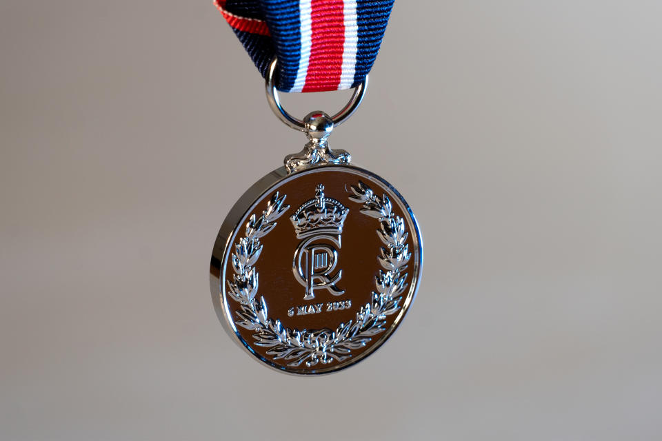 The medal features the royal cypher, a laurel wreath and the coronation date (DCMS/PA)