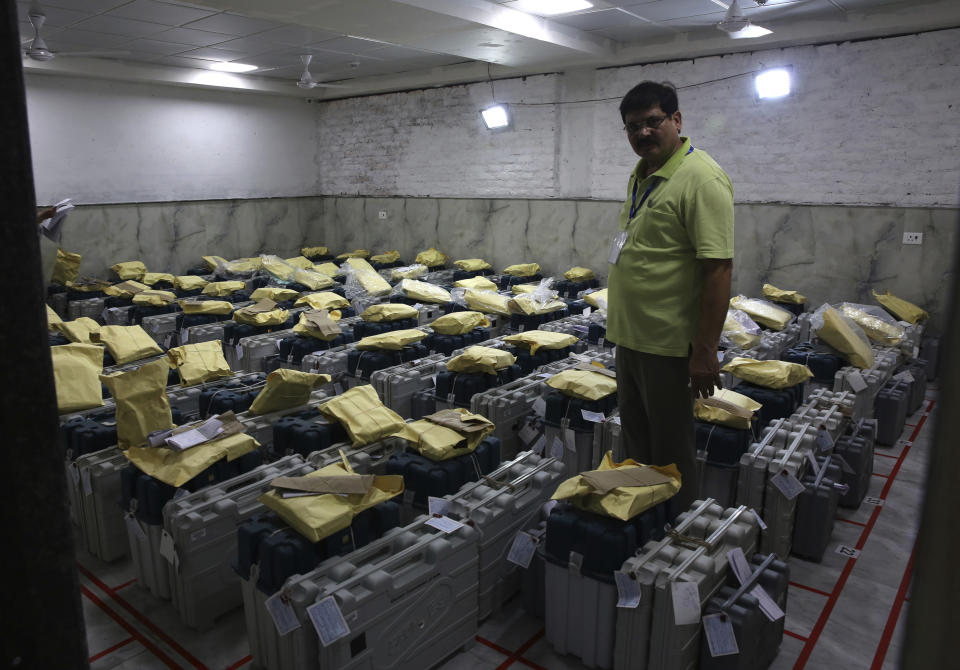 An election official checks electronic voting machines as counting votes of India's massive general elections begins in New Delhi, India, Thursday, May 23, 2019. The count is expected to conclude by the evening, with strong trends visible by midday. (AP Photo/Manish Swarup)