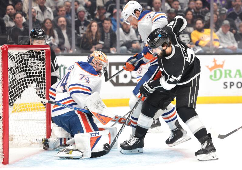 LOS ANGELES, CALIFORNIA - APRIL 26: Kings Phillip Danault tries to get a shot on goal as Oilers goalie Stuart Skinner and Vincent Desharnais defend in the first period in game 3 of the first round of the Stanley Cup Finals. (Wally Skalij/Los Angeles Times)