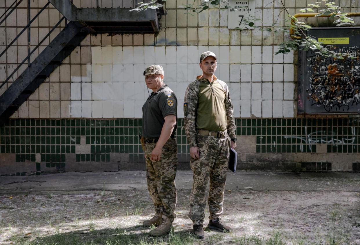 <span>Recruiters Pavlo Pimakhov (left) and Yuriy Pikhota in Kyiv’s suburbs.</span><span>Photograph: Jedrzej Nowicki/The Guardian</span>