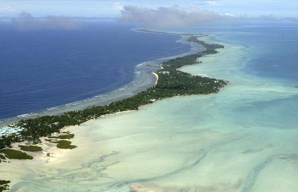 FILE - This March 30, 2004, file photo, shows Tarawa atoll, Kiribati. Ioane Teitiota and his wife fought for years to be allowed to stay in New Zealand as refugees, arguing that rising sea levels caused by global warming threaten the very existence of their tiny Pacific nation of Kiribati, one of the lowest lying countries on Earth. (AP Photo/Richard Vogel, File)