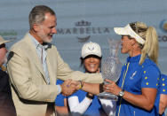 Europe's Team Captain Suzann Pettersen receives the trophy from Spanish King Felipe VI after wining the Solheim Cup golf tournament in Finca Cortesin, near Casares, southern Spain, Sunday, Sept. 24, 2023. Europe has beaten the United States during this biannual women's golf tournament, which played alternately in Europe and the United States. (AP Photo/Bernat Armangue)