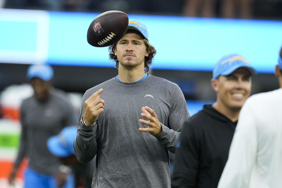 Los Angeles Chargers quarterback Justin Herbert warms up with his team before an NFL football game against the New Orleans Saints in Inglewood, Calif., Sunday, Aug. 20, 2023. (AP Photo/Marcio Jose Sanchez)