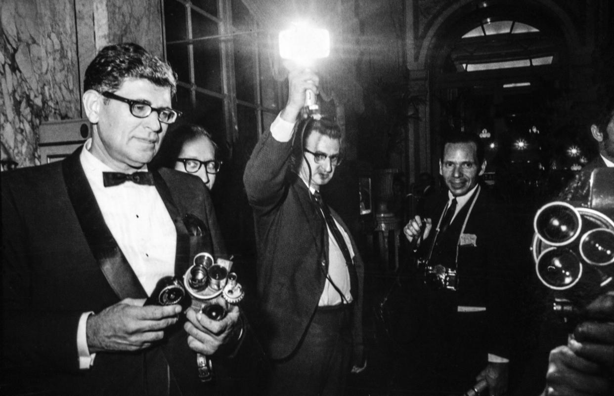 The press take photographs at the Black and White Ball at the Plaza Hotel.<span class="copyright">Santi Visalli—Getty Images</span>