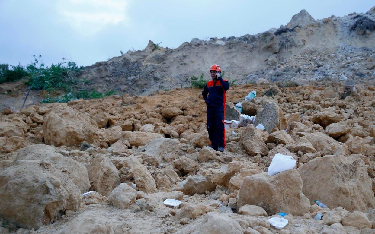 The landslide buried dozens of homes in Naga city, Cebu province in the Philippines - AP