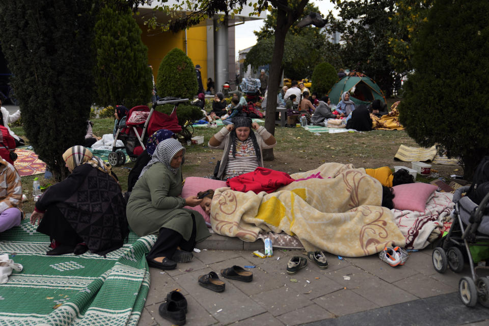 People rest outside their homes in Duzce, Turkey, Wednesday, Nov. 23, 2022, after a magnitude 5.9 earthquake hit a town in northwest Turkey early Wednesday, causing damage to some buildings and widespread panic. At least 68 people were injured, mostly while trying to flee homes. The earthquake was centered in the town of Golkaya, in Duzce province, some 200 kilometers (125 miles) east of Istanbul, the Disaster and Emergency Management Presidency said.(AP Photo/Khalil Hamra)