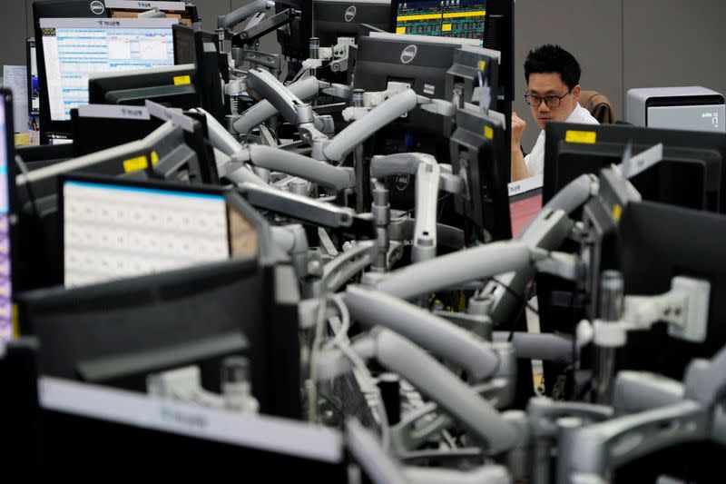 A currency dealer works at a dealing room of a bank in Seoul