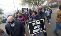 People march during a protest rally for Marcellis Stinnette who was killed by Waukegan Police last Tuesday in Waukegan, Ill., Thursday, Oct. 22, 2020. Stinnette was killed and his girlfriend and mother of his child, Tafara Williams, was wounded when a police officer in Waukegan opened fire Tuesday night after police said Williams' vehicle started rolling toward the officer following a traffic stop. (Brian Hill/Daily Herald via AP)