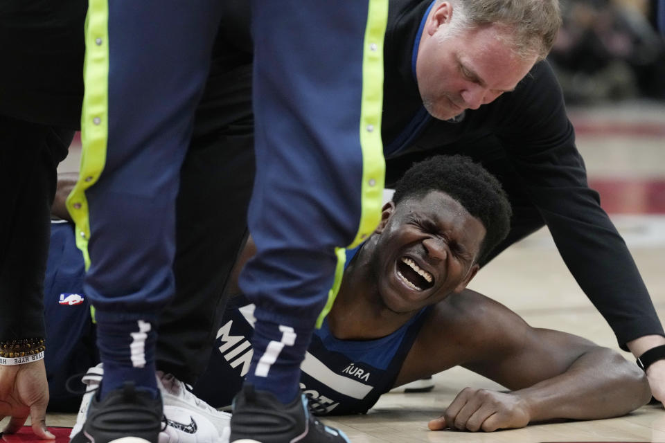 Minnesota Timberwolves guard Anthony Edwards reacts after an apparent injury during the first half of the team's NBA basketball game against the Chicago Bulls in Chicago, Friday, March 17, 2023. (AP Photo/Nam Y. Huh)