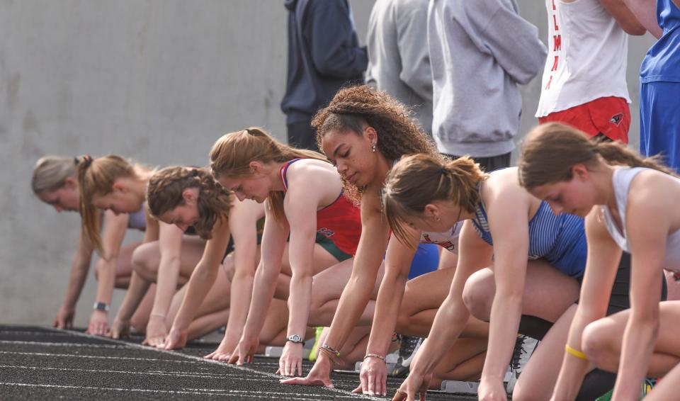 Athletes prepare to begin the 100m hurdles Tuesday, May 24, 2022, at the Central Lakes Conference Championship at Tech High School.