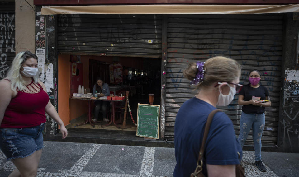 A restaurant remains partially open to sell take-out during a quarantine imposed by the state government to help contain the spread of the new coronavirus in downtown Sao Paulo, Brazil, Monday, April 27, 2020. (AP Photo/Andre Penner)