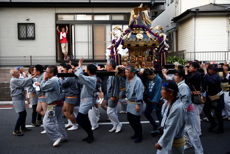 Residents parade with a portable shrine during their Matsuri festival at Sennari district in Sakura, Chiba Prefecture, Japan, July 21, 2018. REUTERS/Kim Kyung-Hoon