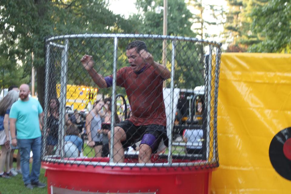 Cambridge Mayor Tom Orr goes for a dip in the dunk tank during National Night Out at Cambridge City Park.