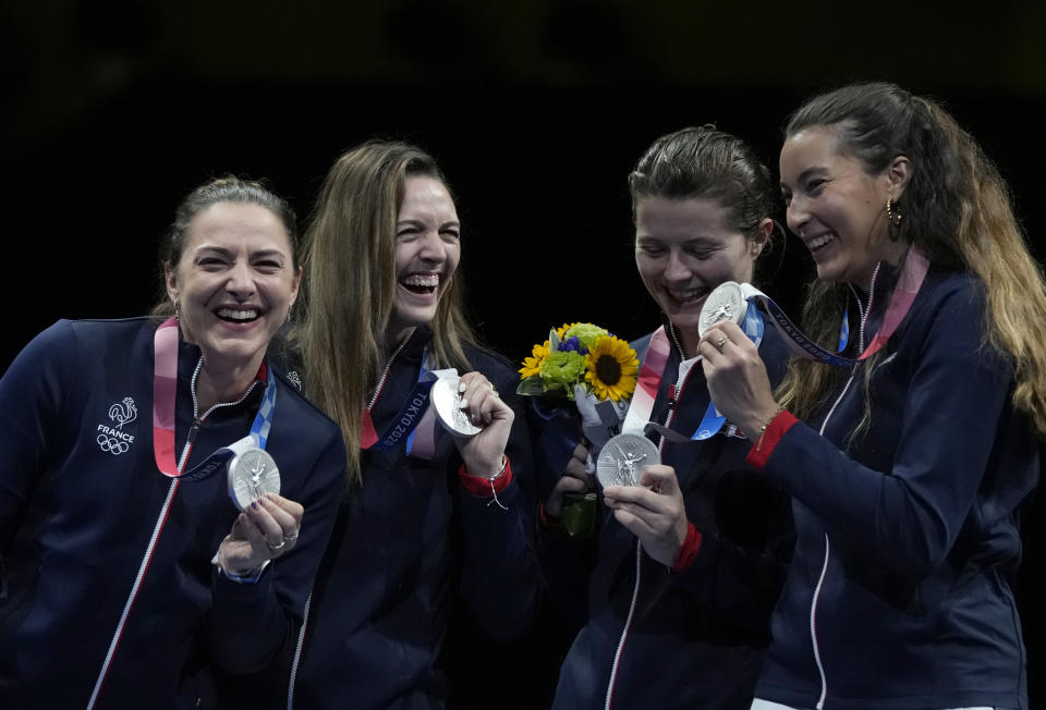 Silver medalists, France Sabre team, celebrate on the podium during the medal ceremony for the women's Sabre team final medal competition at the 2020 Summer Olympics, Saturday, July 31, 2021, in Chiba, Japan. (AP Photo/Hassan Ammar)