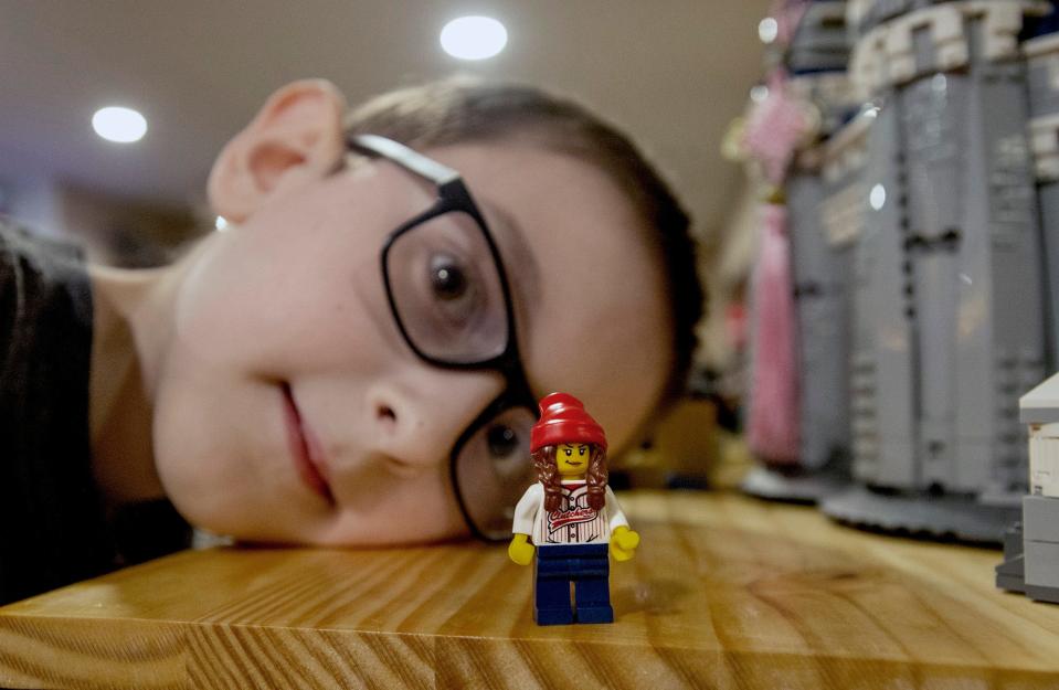 Benjamin Puleo, 9, of Hudson, looks at a "sigfig" signature miniature figure of his mom, Liz, who is on the Fox television show "Lego Masters," Oct. 3, 2022.