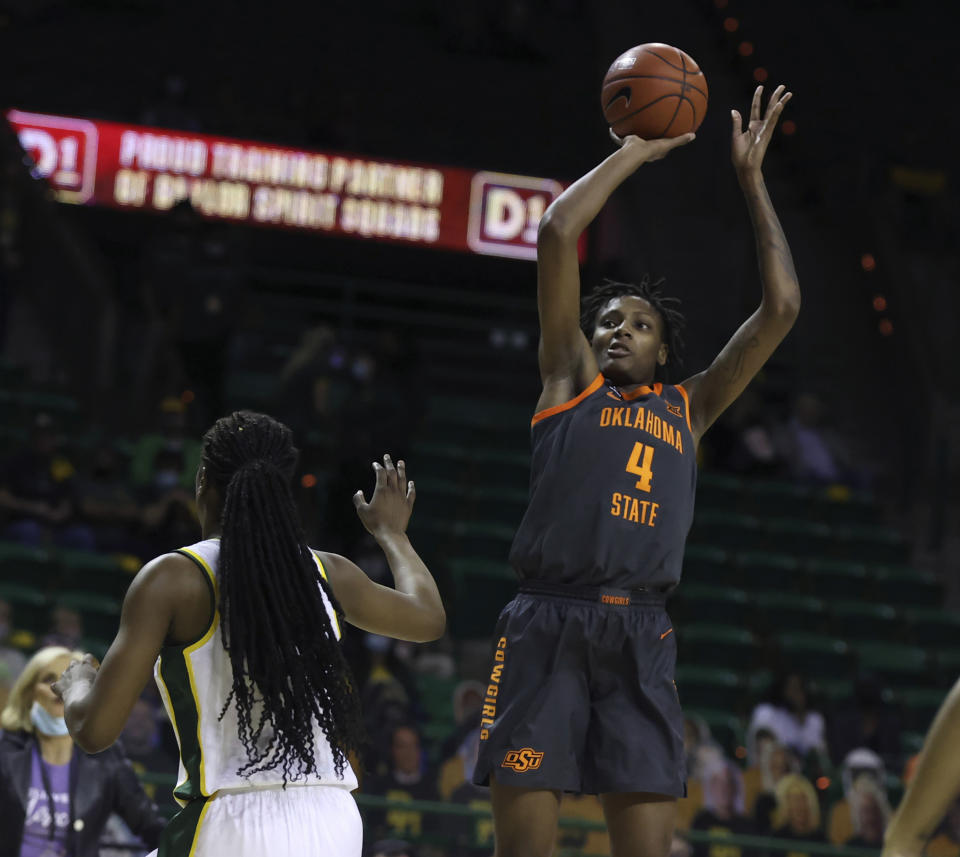 Oklahoma State forward Natasha Mack, right, scores over Baylor center Queen Egbo, left, during the first half of an NCAA college basketball game, Wednesday, Feb. 24, 2021, in Waco, Texas. (Rod Aydelotte/Waco Tribune-Herald via AP)