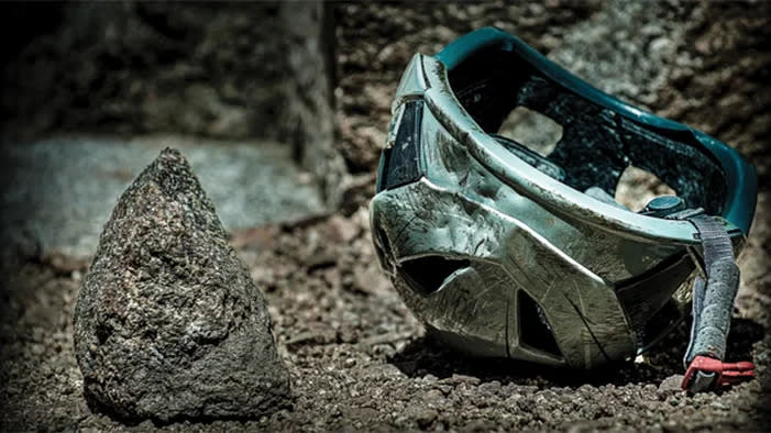 Helmet crushed by rockfall.