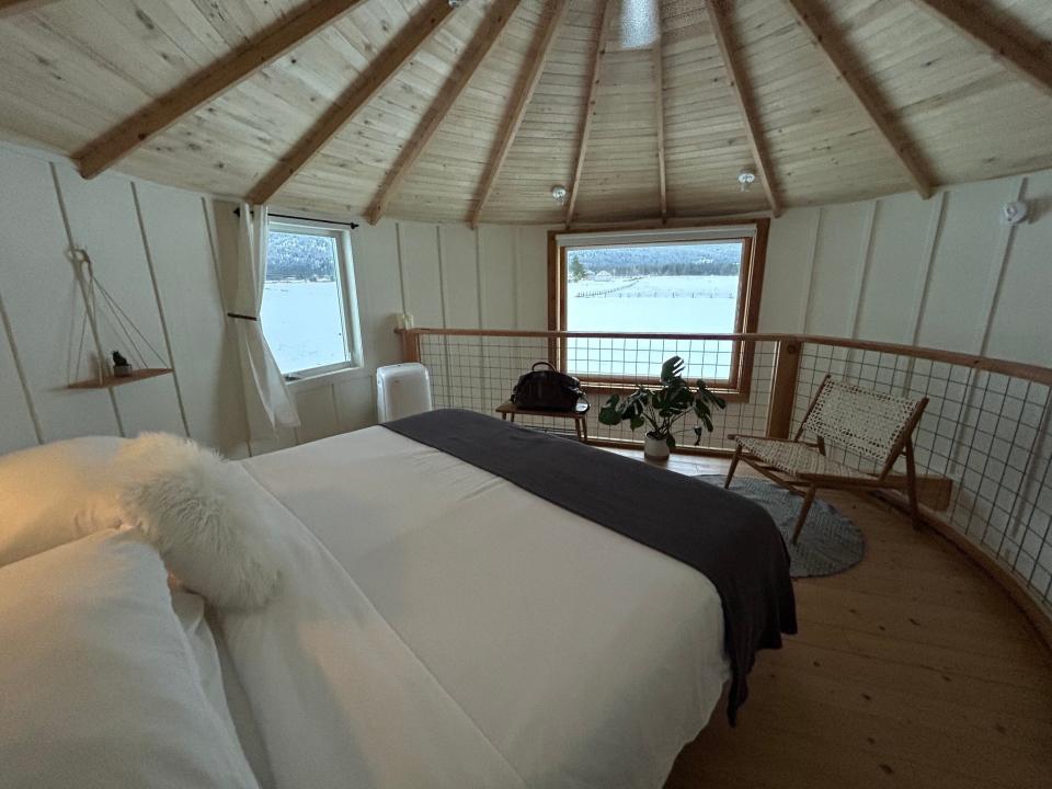 A king-sized bed inside a round, lofted bedroom.