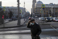 A man wearing a face mask to protect against coronavirus walks along a street in Moscow, Russia, Wednesday, Dec. 2, 2020. Russia has registered a record number of coronavirus deaths for a second straight day. (AP Photo/Pavel Golovkin)