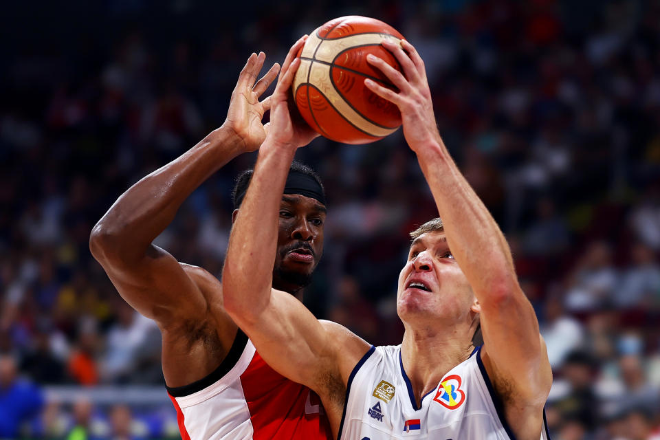 MANILA, PHILIPPINES – SEPTEMBER 08: <a class="link " href="https://sports.yahoo.com/nba/players/5338" data-i13n="sec:content-canvas;subsec:anchor_text;elm:context_link" data-ylk="slk:Bogdan Bogdanovic;sec:content-canvas;subsec:anchor_text;elm:context_link;itc:0">Bogdan Bogdanovic</a> #7 of Serbia drives to the basket against Shai Gilgeous-Alexander #2 of Canada in the second quarter during the FIBA Basketball World Cup semifinal game at Mall of Asia Arena on September 08, 2023 in Manila, Philippines. (Photo by Yong Teck Lim/Getty Images)
