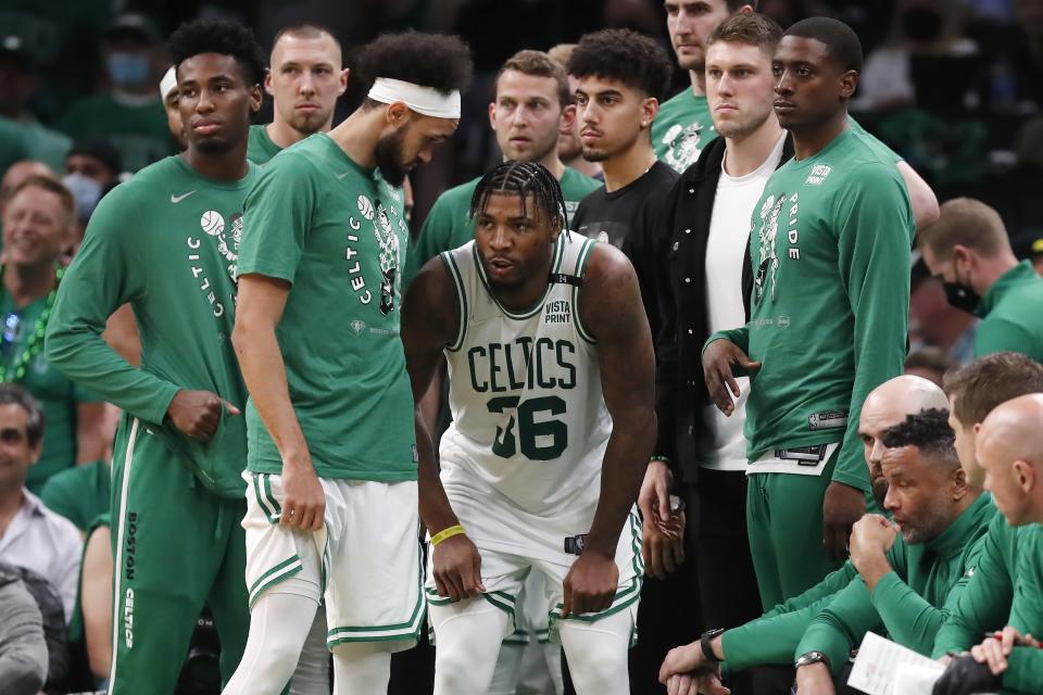 Boston Celtics' Marcus Smart come back on the court after leaving temporarily with an injury during the second half of Game 3 of the team's NBA basketball playoffs Eastern Conference finals against the Miami Heat, Saturday, May 21, 2022, in Boston. (AP Photo/Michael Dwyer)