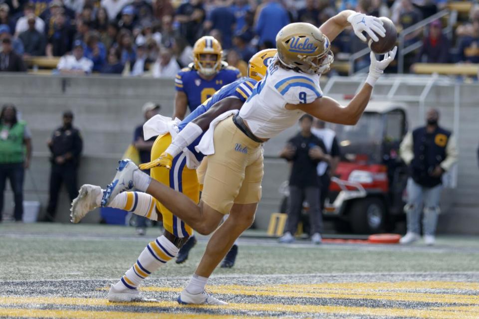 UCLA wide receiver Jake Bobo catches a touchdown pass in front of California safety Craig Woodson in November.