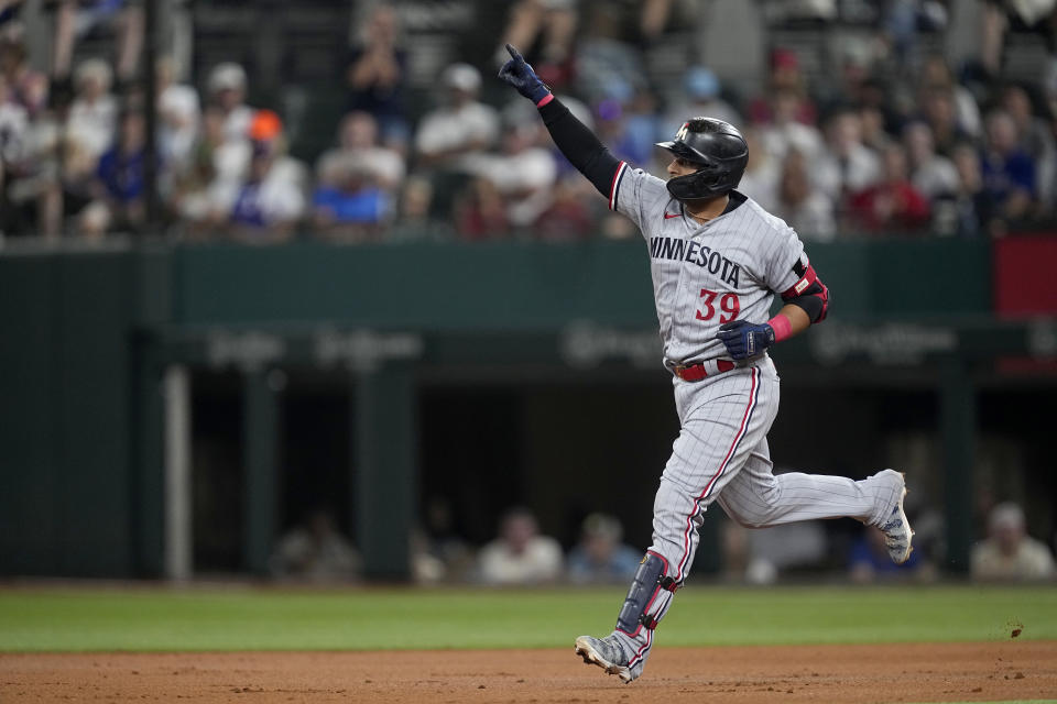 Minnesota Twins' Donovan Solano celebrates after his solo home run as he rounds the bases in the third inning of a baseball game against the Texas Rangers, Saturday, Sept. 2, 2023, in Arlington, Texas. (AP Photo/Tony Gutierrez)