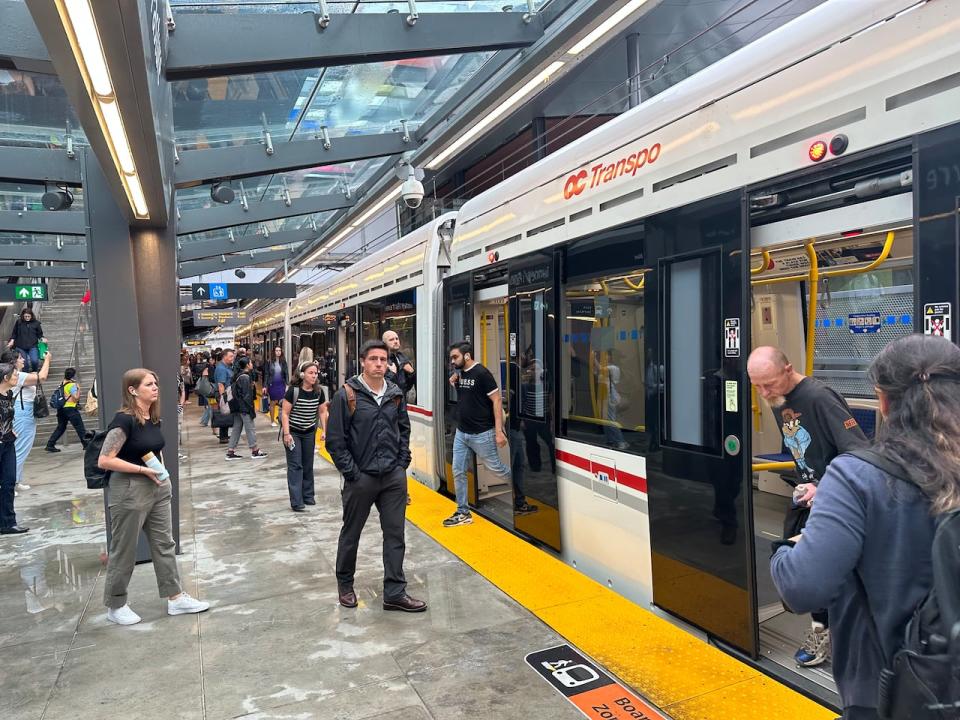 Passengers wait to board a light rail train at Tunney's Pasture Station on Tuesday morning.