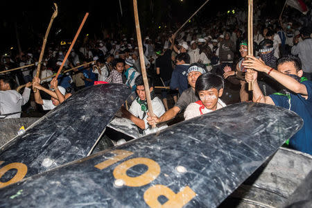 Muslim hardline protesters clash with anti-riot policemen during a protest against Jakarta's incumbent governor Basuki (Ahok) Tjahaja Purnama, an ethnic Chinese Christian running in the upcoming election, in Jakarta, Indonesia. Antara Foto/M Agung Rajasa/via REUTERS