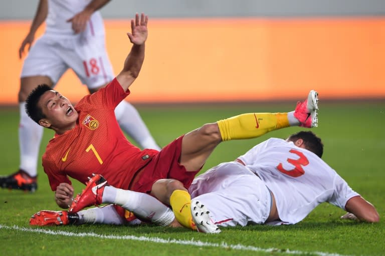 Goal-shy: China forward Wu Lei (left) is tackled by Dusko Tosic as another chance goes begging against Serbia