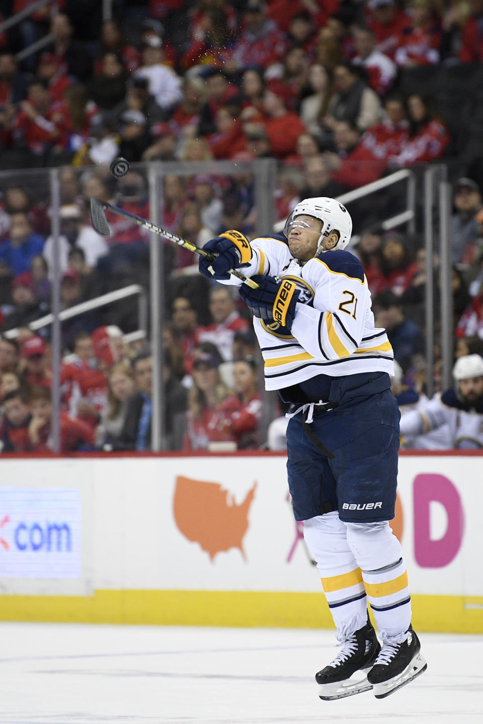Buffalo Sabres right wing Kyle Okposo (21) swings at the airborne puck during the first period of an NHL hockey game against the Washington Capitals, Saturday, Dec. 15, 2018, in Washington. (AP Photo/Nick Wass)
