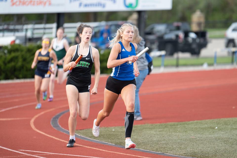 Harper Creek senior Maddie Berning competes in the mixed sprint relay race during the invitational meet at Harper Creek High School on Friday, May 5, 2023.