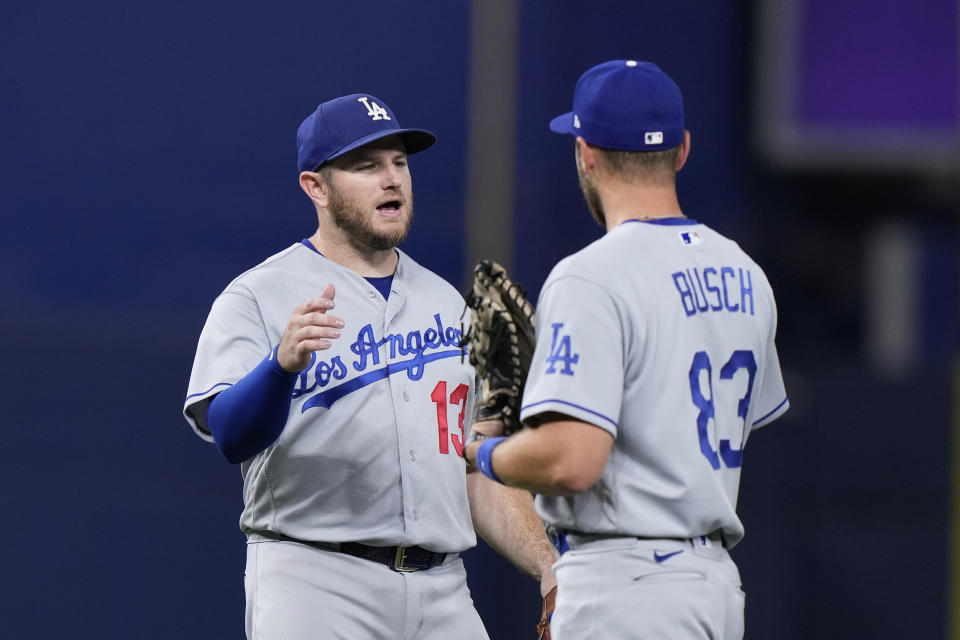 Los Angeles Dodgers third baseman Max Muncy (13) and first baseman Michael Busch (83) congratulate each other after the Dodgers defeated the Miami Marlins 10-0 in a baseball game Thursday, Sept. 7, 2023, in Miami. (AP Photo/Wilfredo Lee)