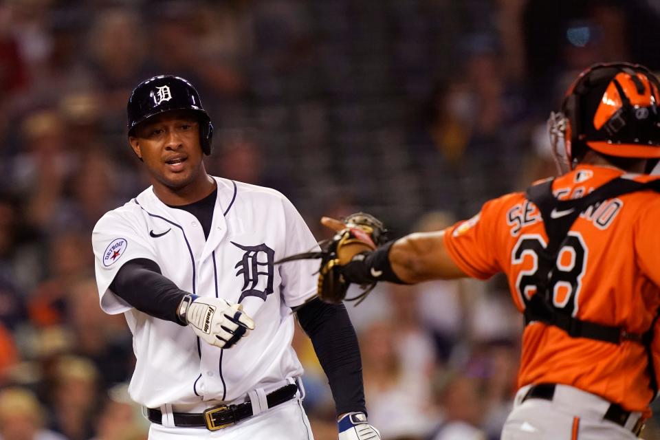 Detroit Tigers' Jonathan Schoop argues his strike call with umpire Ramon De Jesus as Baltimore Orioles catcher Pedro Severino walks off to celebrate the Orioles' 5-2 win after a baseball game, Saturday, July 31, 2021, in Detroit.