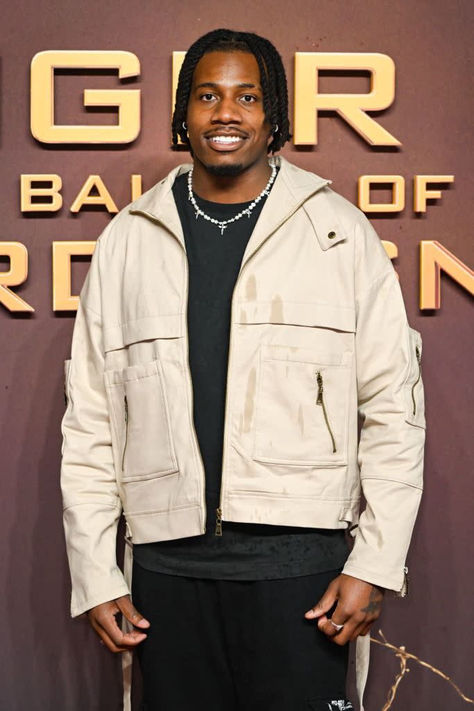 Shaq in a layered jacket and necklace smiling at a 'Game of Thrones' event