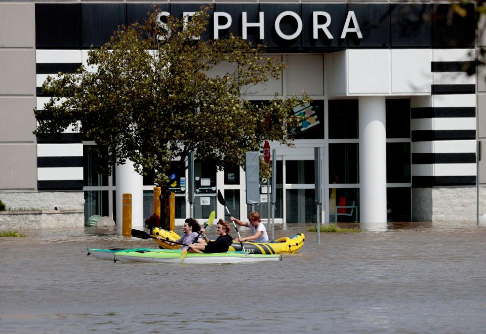Kayakers head past a Sephora in the New Towne Center strip mall near Ford and Sheldon Roads in Canton after a big thunderstorm dumped several inches of rain in the area in the early morning hours of Thursday, Aug. 24, 2023.