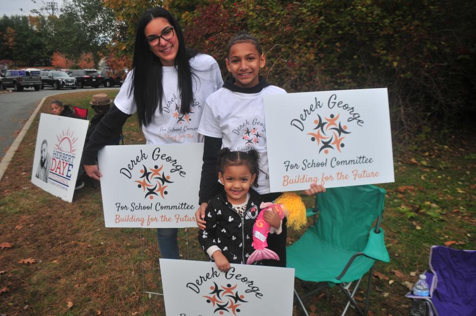 The family of Taunton School Committee candidate Derek George held signs for him outside the Ward 3 voting place at the new Pole School on Tuesday, Nov. 2, 2021. From left: Veronika George, wife of Derek George; Derek Jr., 11; and Victoria, 4.