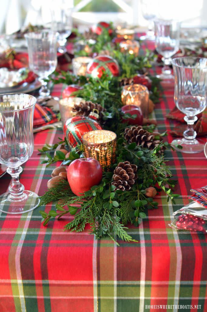 <p>Leyland cypress, mercury glass votives, and pinecones lend a rustic yet festive air to this Christmas table. </p><p><strong>Get the tutorial at <a href="https://homeiswheretheboatis.net/2016/11/28/plaid-tidings-christmas-table-with-st-nick-and-a-natural-evergreen-table-runner/" rel="nofollow noopener" target="_blank" data-ylk="slk:Home Is Where the Boat Is;elm:context_link;itc:0;sec:content-canvas" class="link ">Home Is Where the Boat Is</a>.</strong> </p><p><strong><a class="link " href="https://www.amazon.com/Christmas-Artificial-Garland-Assorted-Eucalyptus/dp/B07KLJJ3DT/ref=sr_1_6?tag=syn-yahoo-20&ascsubtag=%5Bartid%7C10050.g.644%5Bsrc%7Cyahoo-us" rel="nofollow noopener" target="_blank" data-ylk="slk:Shop Now;elm:context_link;itc:0;sec:content-canvas">Shop Now</a><br></strong></p>