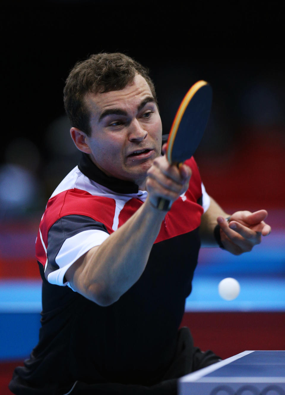 "Heeyah!" <br> LONDON, ENGLAND - JULY 28: Pierre-Luc Hinse of Canada plays a forehand against Matiss Burgis of Latvia during their Men's Singles Table Tennis match on Day 1 of the London 2012 Olympic Games at ExCeL on July 28, 2012 in London, England. (Photo by Feng Li/Getty Images)