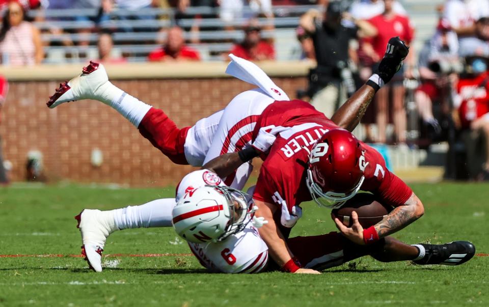 Nebraska safety Marquel Dismuke (9) tackles Oklahoma quarterback Spencer Rattler (7) during the second quarter at Gaylord Family-Oklahoma Memorial Stadium.