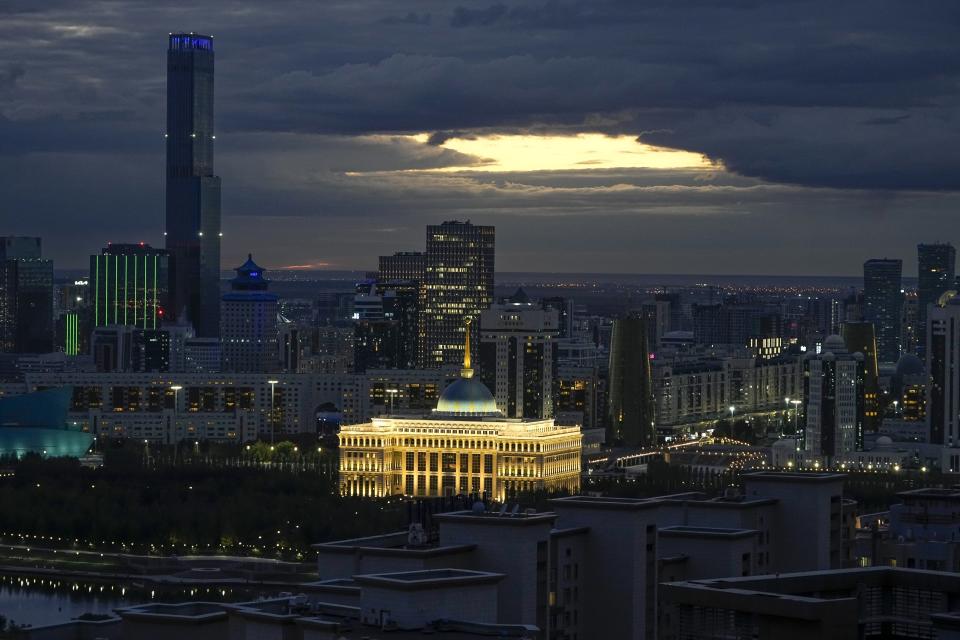 FILE - A night view of the capital Astana, former name Nur-Sultan, Kazakhstan, with the Presidential Palace seen in the center, Monday, Sept. 12, 2022. Voters in Kazakhstan cast ballots Sunday, March 18, 2023 after a short but active campaign for seats in the lower house of parliament that is being reconfigured in the wake of deadly unrest that gripped the resource-rich Central Asian nation a year ago. Amid the violence, Tokayev removed Nazarbayev from his powerful post as head of the national security council. He restored the capital's previous name of Astana, and the parliament repealed a law granting Nazarbayev and his family immunity from prosecution. (AP Photo/Alexander Zemlianichenko, File)