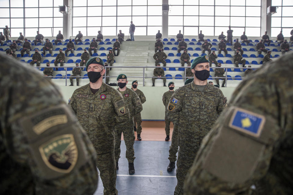 Kosovo Security Force (KSF) members wearing protective face masks line up, during a peacekeeping mission deployment ceremony held at the army barracks in Pristina, Tuesday, March 9, 2021. Kosovo is sending a military platoon to Kuwait, its first ever involvement in an international peacekeeping mission. A ceremony was held Tuesday at the army barracks in the capital, Pristina, with the presence of top country leaders and western military attaches. Kosovo is sending the military unit following a request from the U.S. Central Command. (AP Photo/Visar Kryeziu)